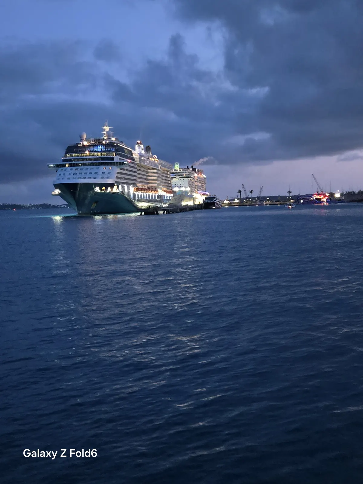 the cruise hq cruise ship glowing under stormy evening clouds at royal naval dockyard bermuda