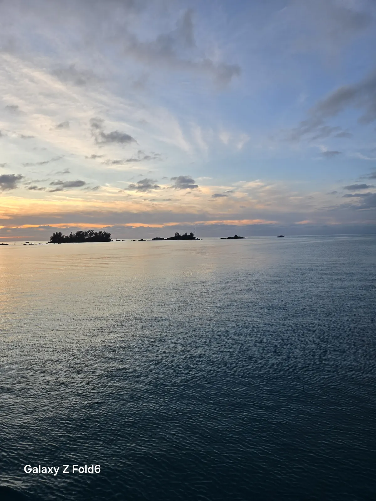 the cruise hq calm water and small islands under a pastel twilight sky in bermuda's great sound