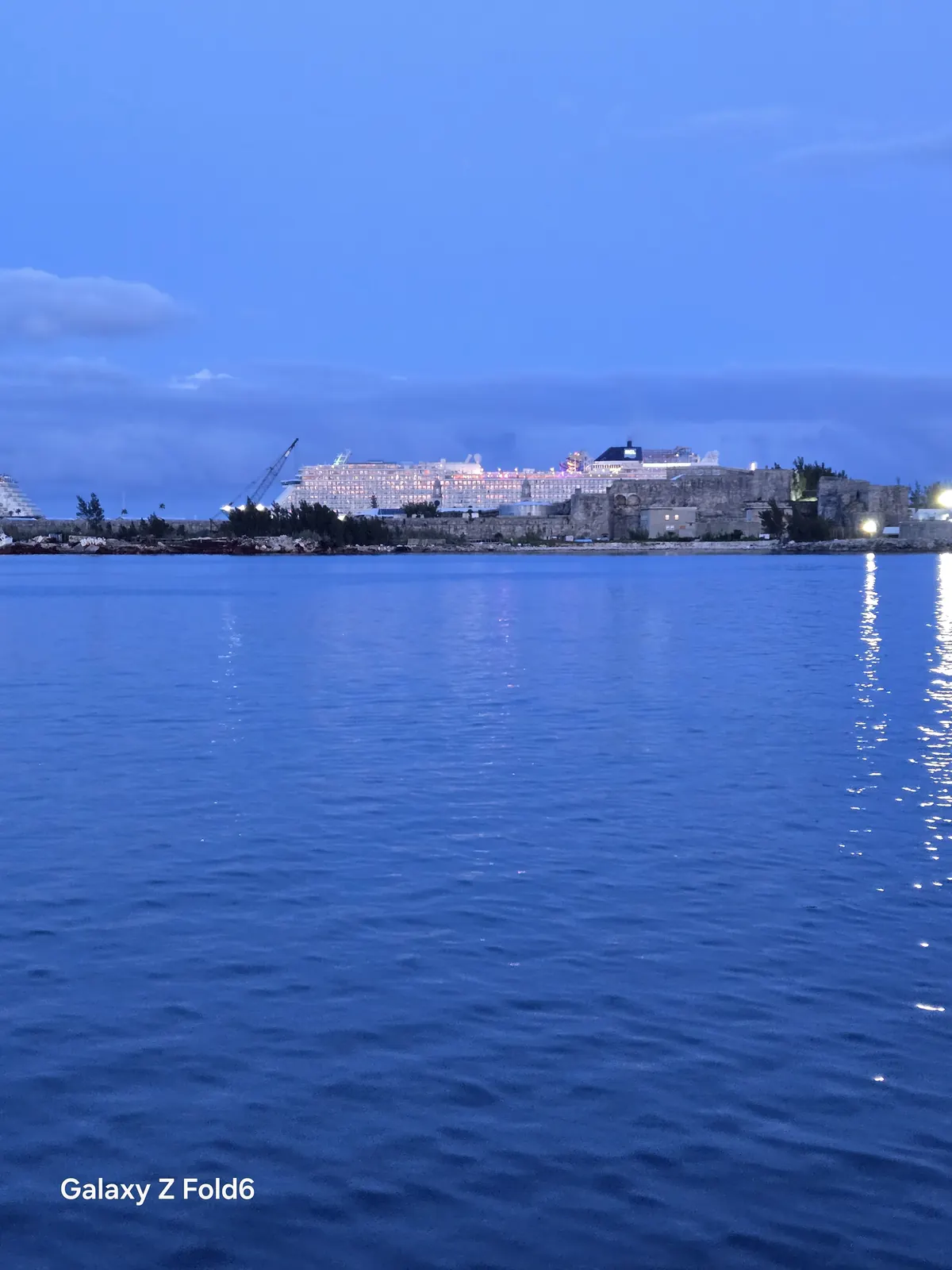 the cruise hq cruise ships lit up at king's wharf royal naval dockyard seen across the water at blue hour