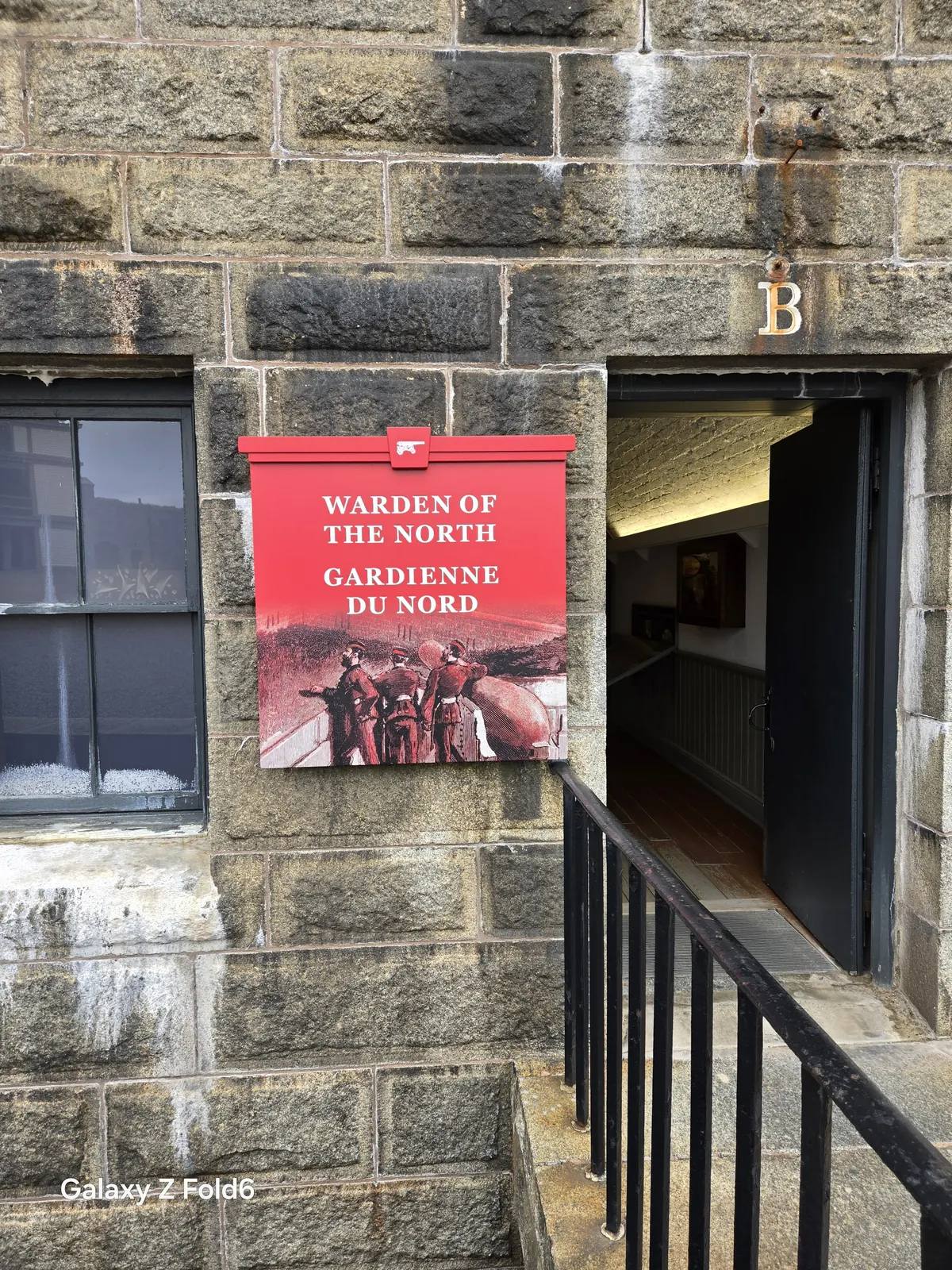 the cruise hq red sign reading warden of the north beside an open doorway at halifax citadel