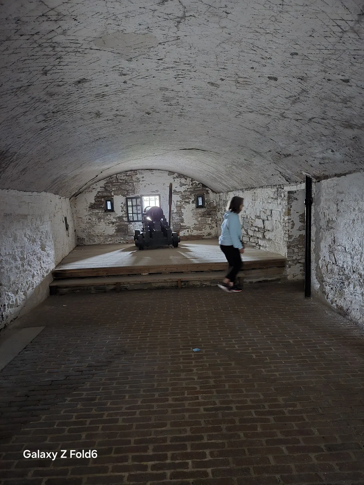 the cruise hq vaulted stone gun room with a cannon facing the window at halifax citadel