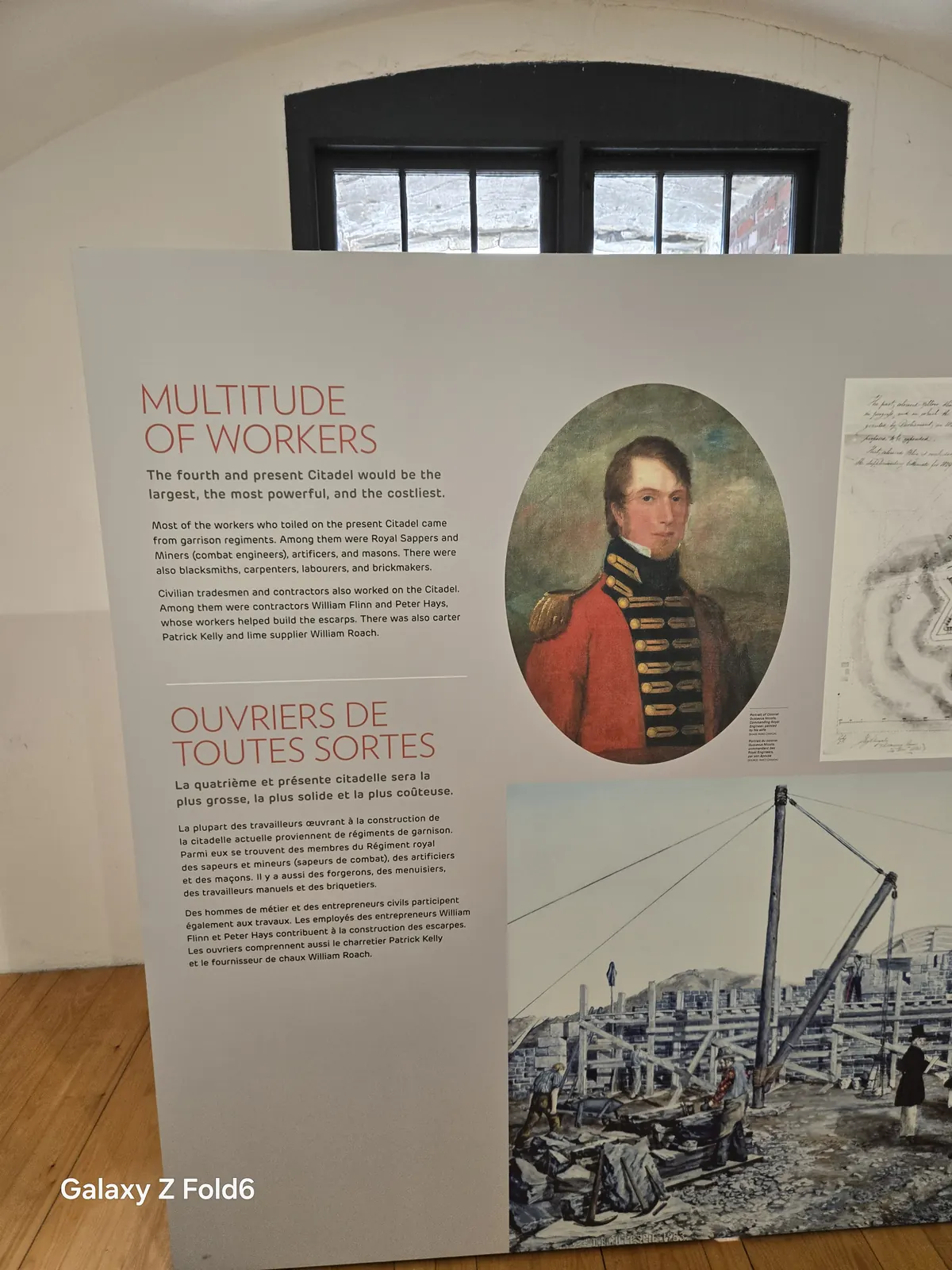 the cruise hq museum panel titled multitude of workers with a portrait and construction photos at halifax citadel