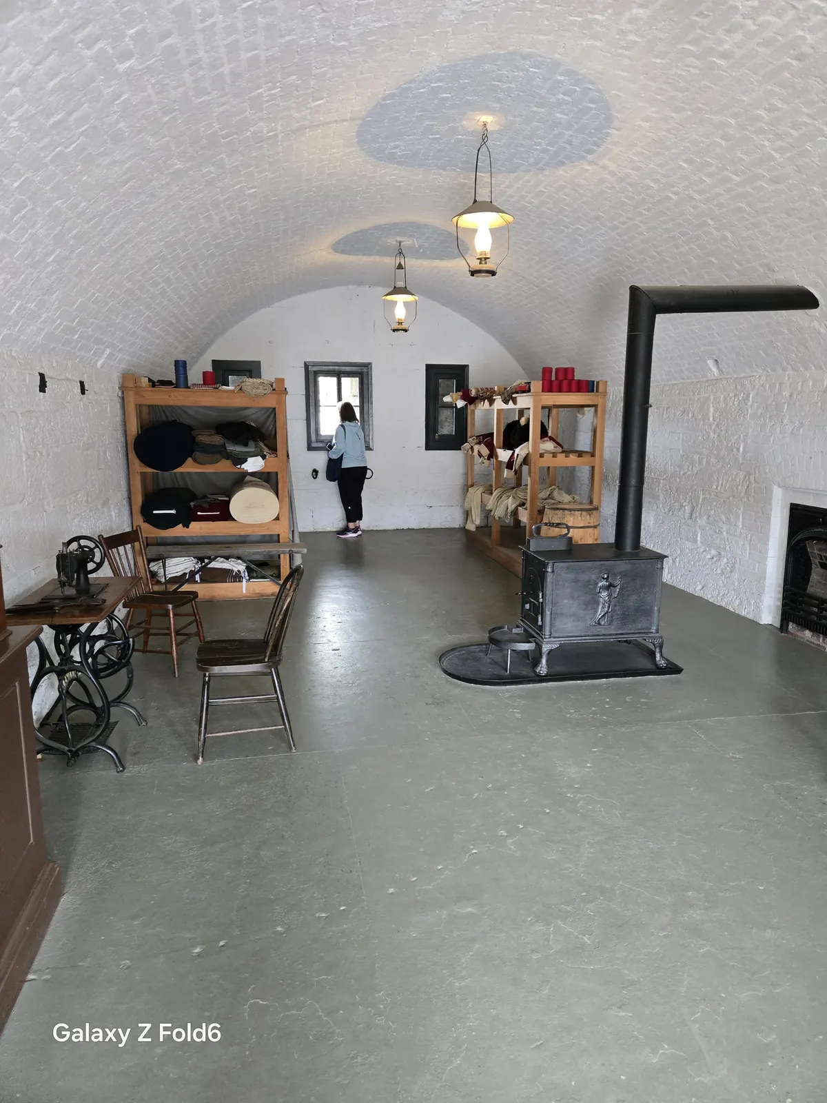 the cruise hq tailor shop with shelves of uniforms and a cast iron stove at halifax citadel