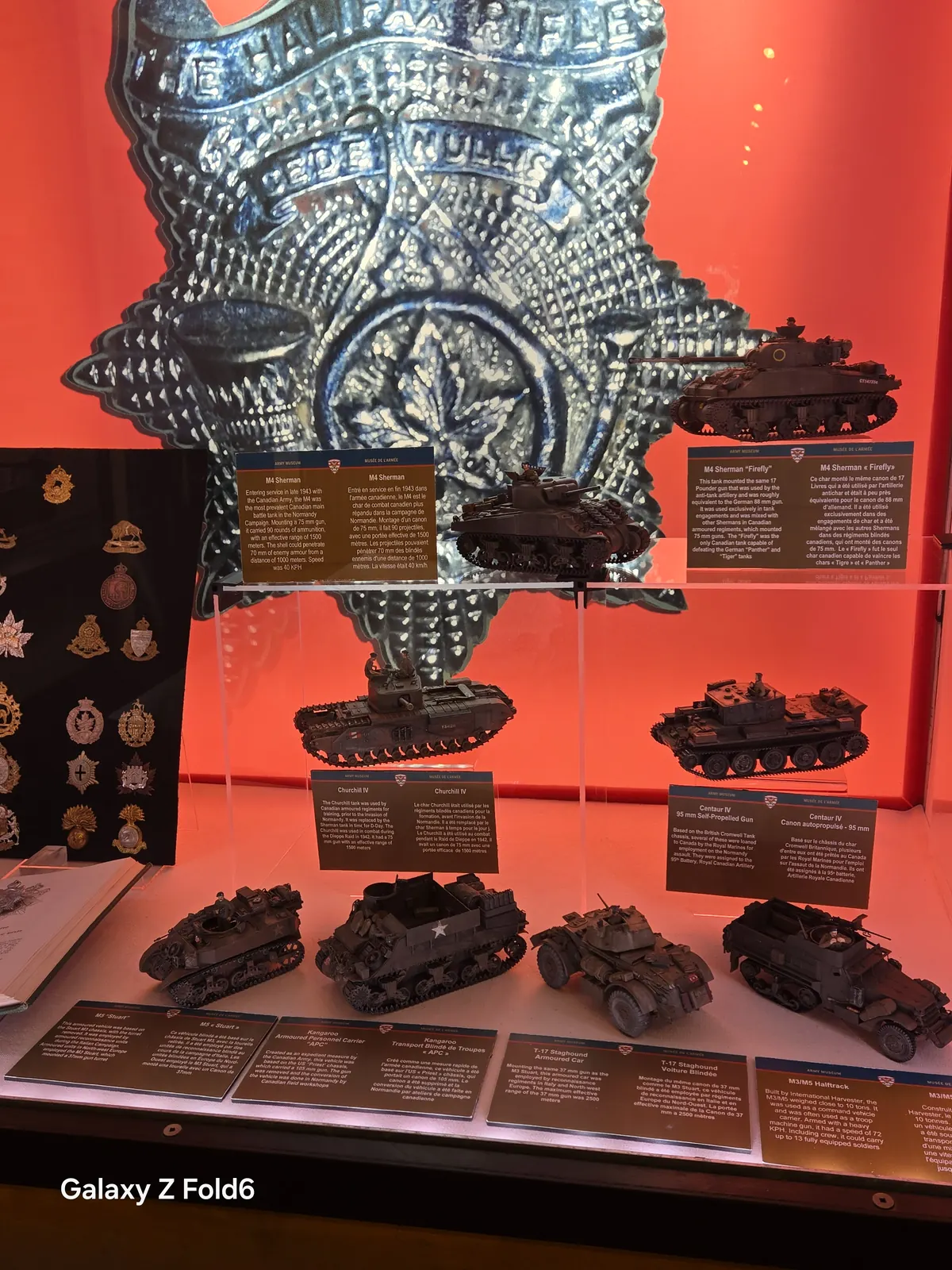the cruise hq regimental badges and model tanks in a red lit display at halifax citadel