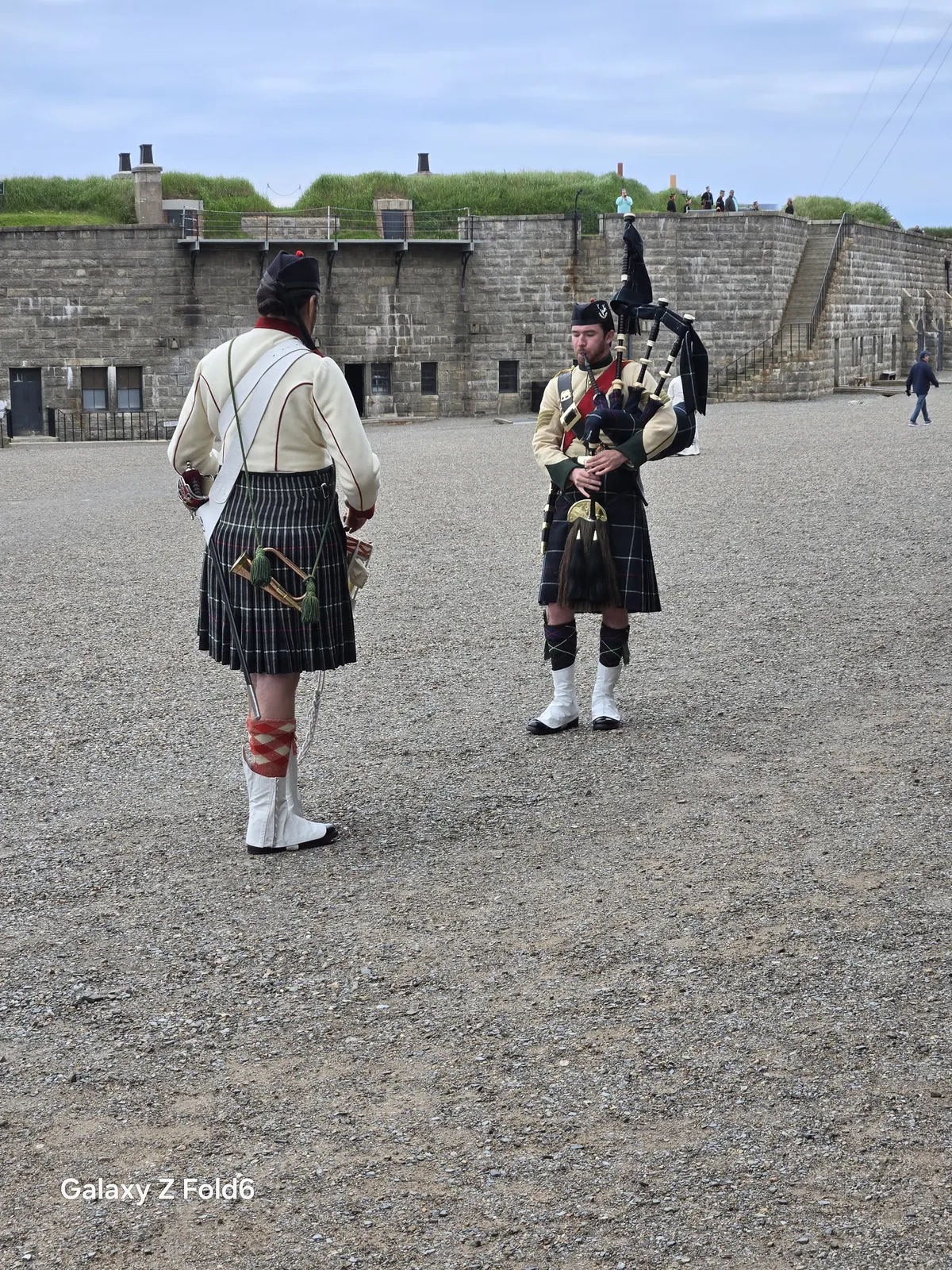 the cruise hq a bagpiper and a soldier in 78th highlanders uniform on the parade square at halifax citadel