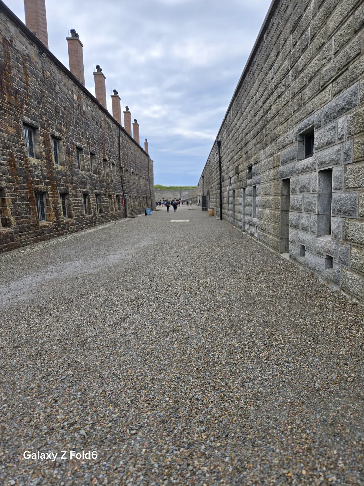 the cruise hq long stone barracks walls lining a gravel lane at halifax citadel