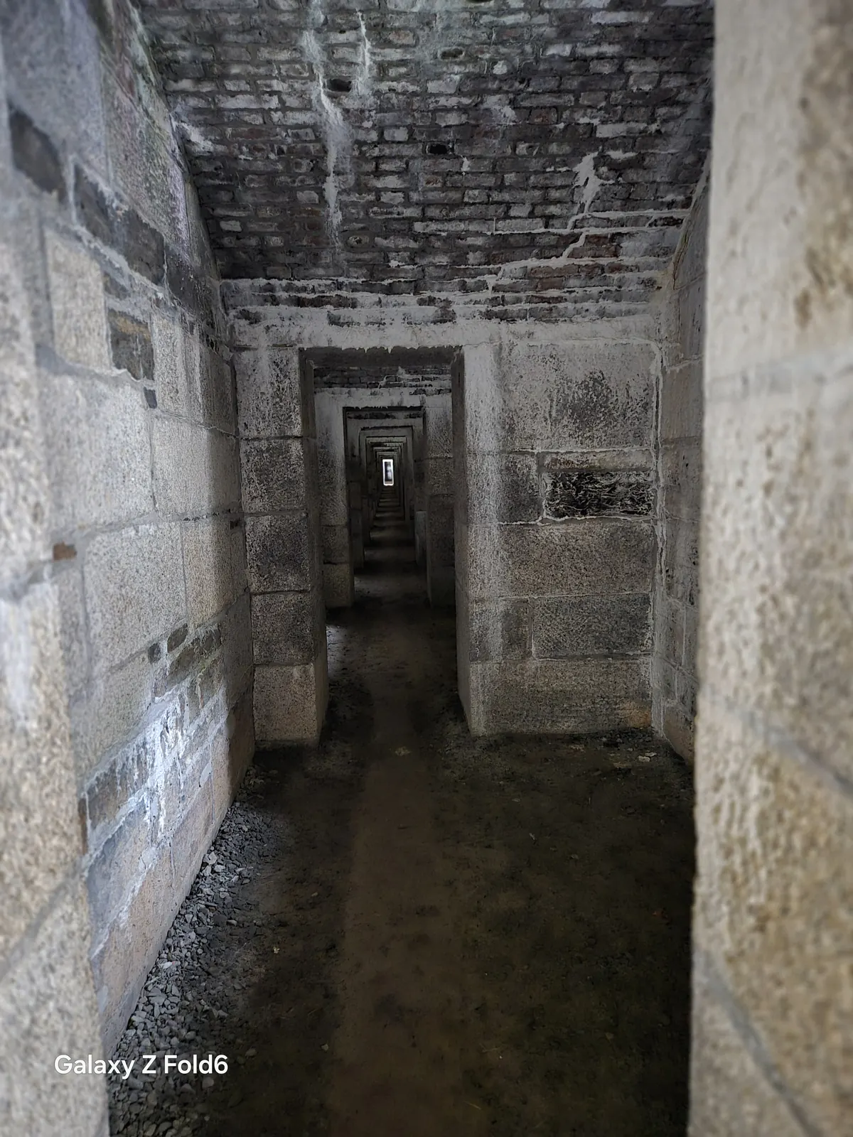 the cruise hq long narrow stone tunnel with a series of doorways at halifax citadel