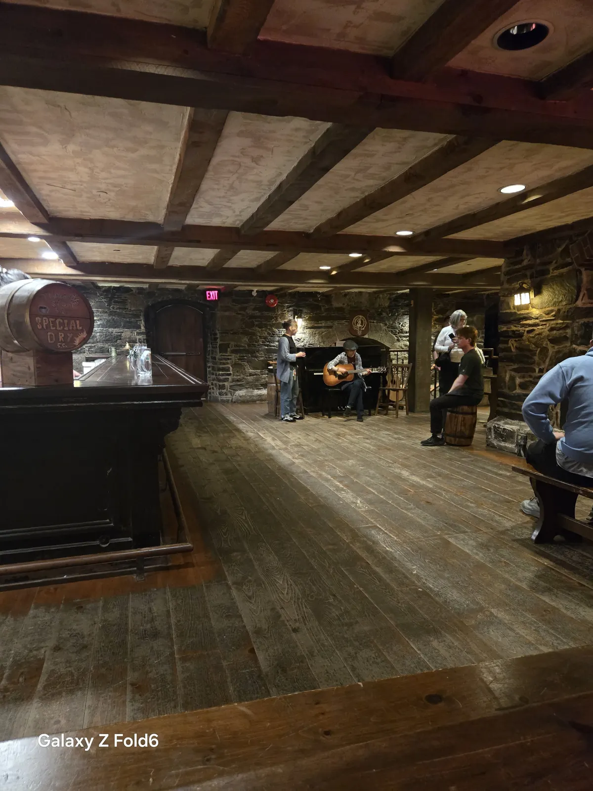 the cruise hq musicians playing guitar beside a piano in the stone walled brewery cellar pub at alexander keith's Brewery in Halifax