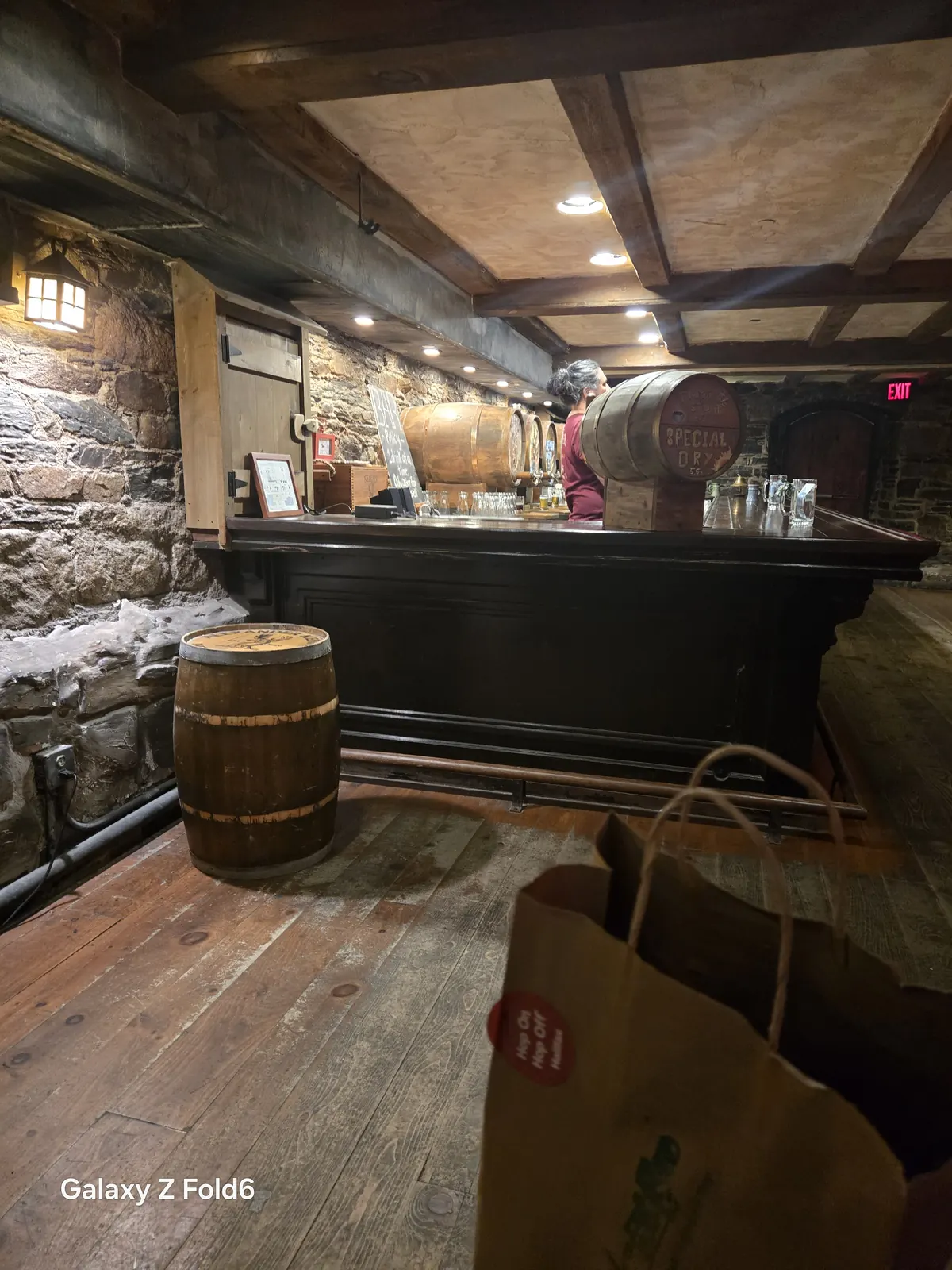 the cruise hq wooden barrel and bar with taps against a stone wall in the cellar at alexander keith's Brewery in Halifax