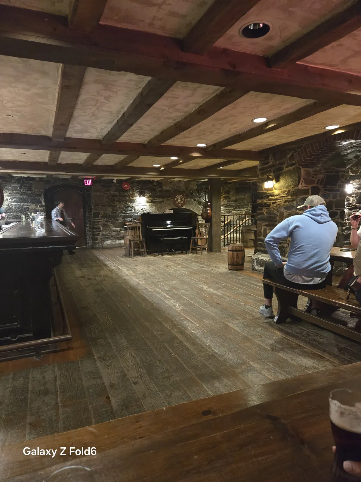 the cruise hq long wooden floor bar and benches in the beamed stone cellar pub at alexander keith's Brewery in Halifax