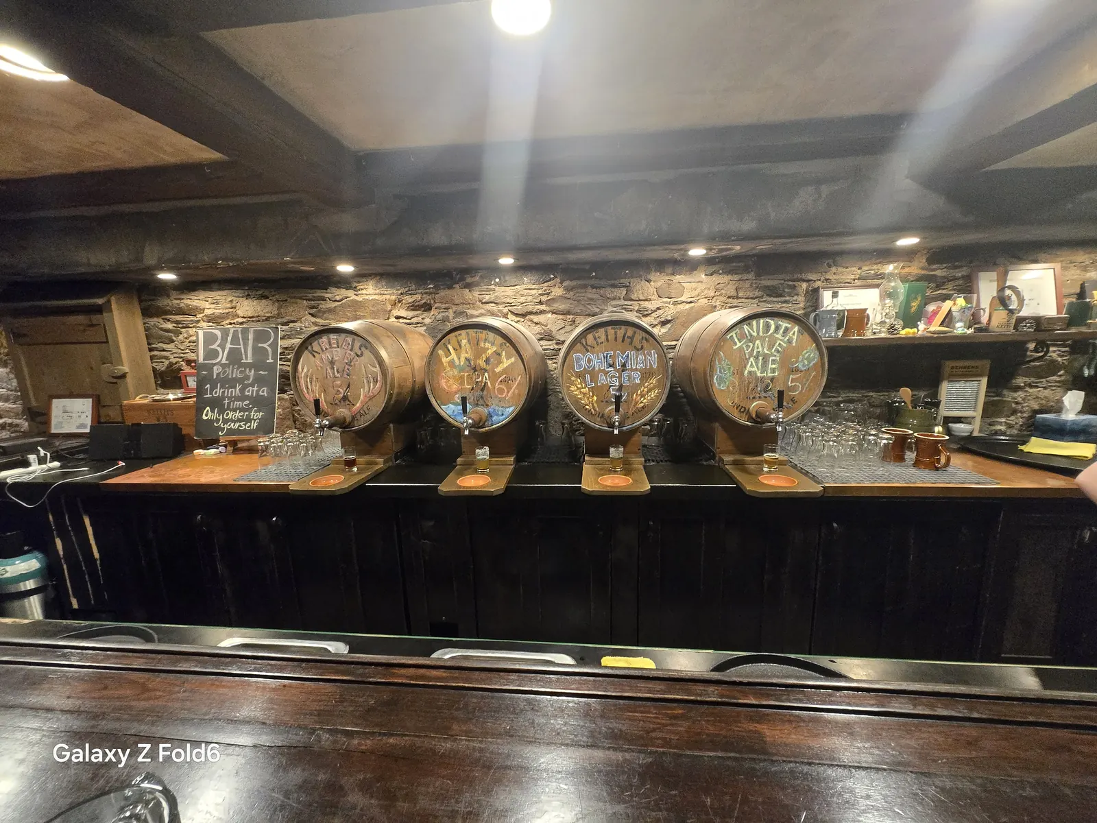 the cruise hq four painted beer barrels with taps along the bar at alexander keith's Brewery in Halifax