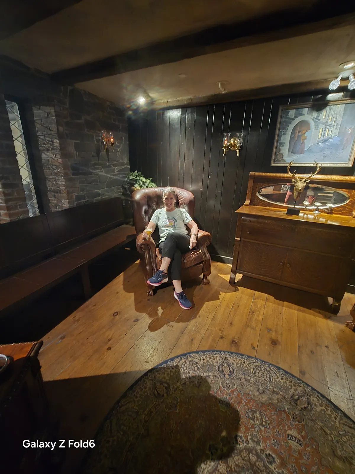 the cruise hq visitor relaxing in a leather armchair in a wood panelled parlour at alexander keith's Brewery in Halifax
