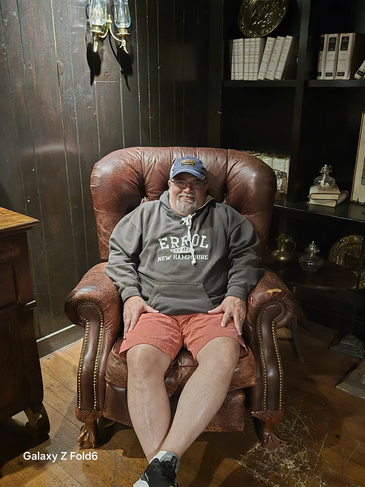 the cruise hq visitor seated in a leather armchair in a wood panelled library corner at alexander keith's Brewery in Halifax